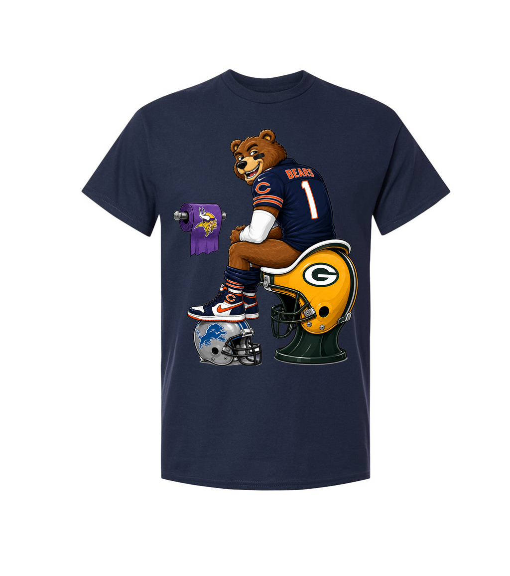 A navy blue short-sleeve t-shirt featuring a cartoon graphic of a Chicago Bears bear mascot sitting on a Green Bay Packers football helmet, with a purple Minnesota Vikings toilet paper roll and a football helmet nearby, displayed on a solid white background.